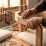 Craftsman hand-sanding the curved beech armrest of a Eurus dining chair in an Inegol workshop
